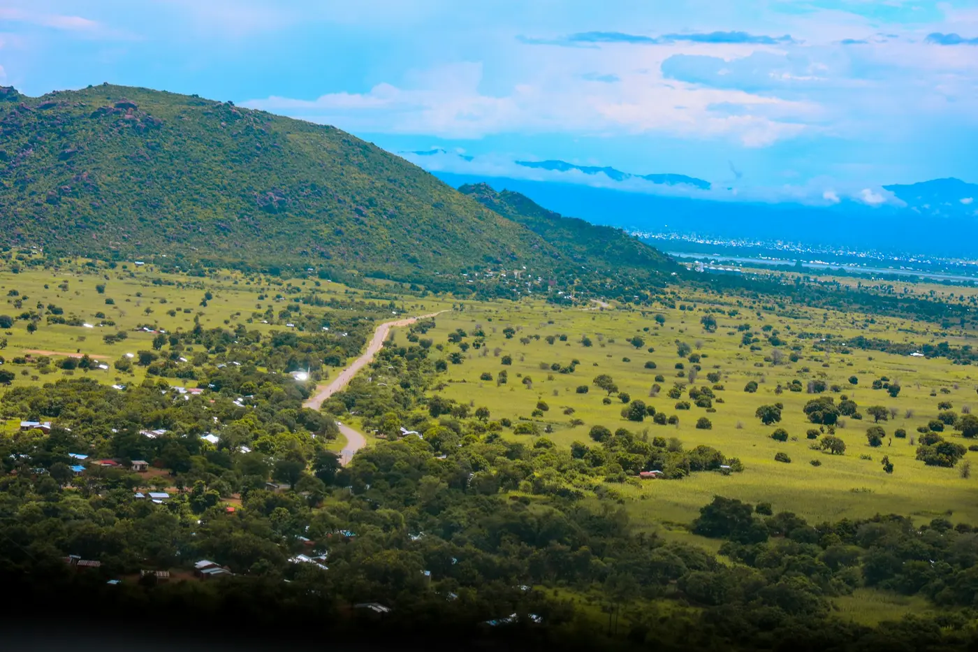 A road winding through green countryside near Mangochi, Malawi